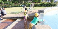 フラワーガーデンの水遊び場で遊ぶ児童